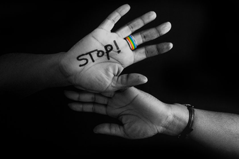 black and white image of someone's hand with the word "Stop" written