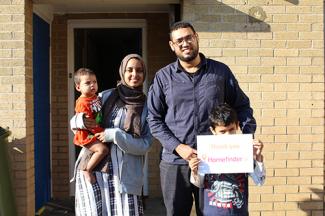 Muslim family holding sign saying "Thank you, Homefinder UK"