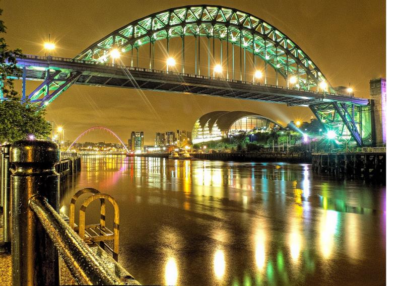 Photo of an illuminated Gateshead Millennium Bridge