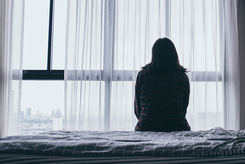 woman looking out of window